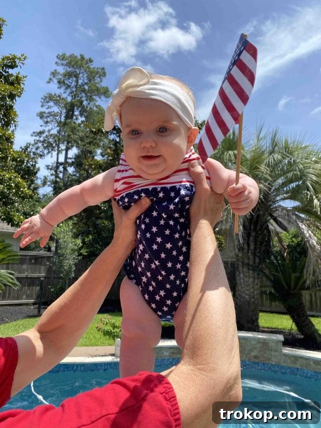A sweet photo of baby Luca, adorable in her 4th of July themed attire, celebrating her first patriotic holiday.