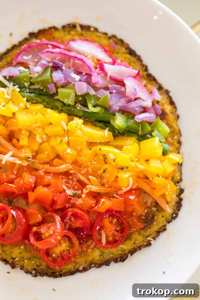 Guilt-Free Cauliflower Pizza Crust for Your Low-Carb Lifestyle 11 A vibrant pizza with rainbow veggie toppings on a gluten-free cauliflower crust, just out of the oven