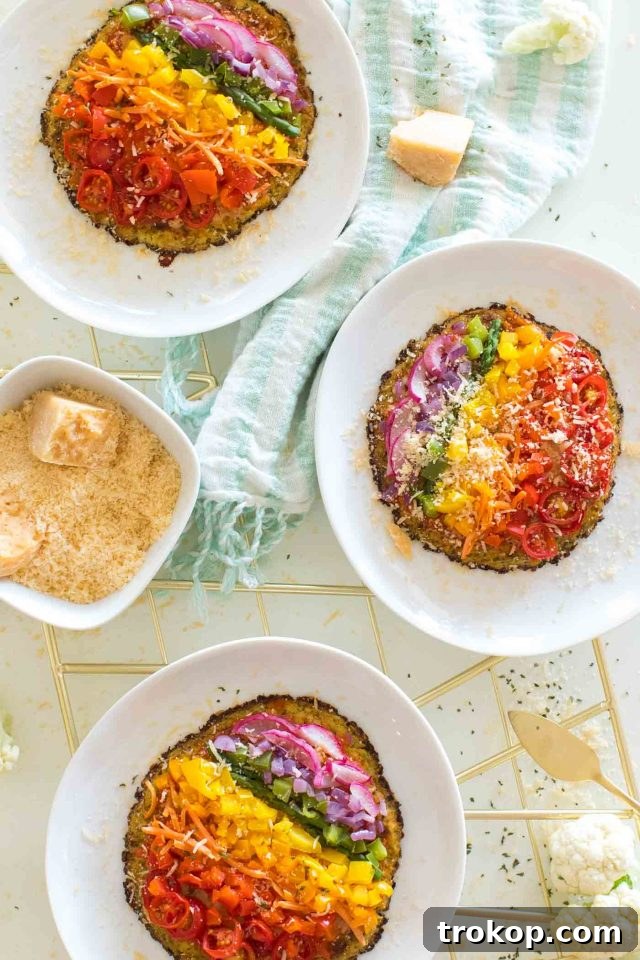 Guilt-Free Cauliflower Pizza Crust for Your Low-Carb Lifestyle 14 Three mini cauliflower crust pizzas with colorful veggie toppings arranged artfully