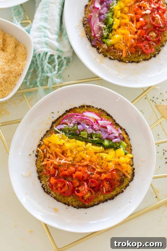 Guilt-Free Cauliflower Pizza Crust for Your Low-Carb Lifestyle 3 Gluten-free cauliflower pizza dough adorned with vibrant rainbow vegetable toppings
