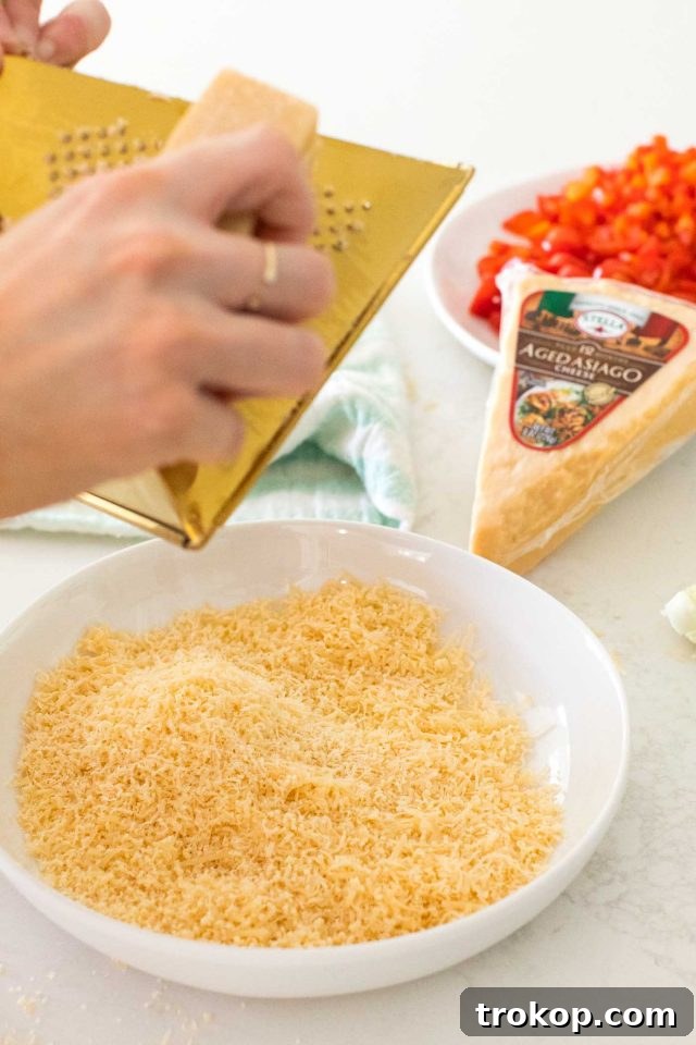 Guilt-Free Cauliflower Pizza Crust for Your Low-Carb Lifestyle 5 Freshly grated Stella Aged Asiago cheese wedge, ready for cauliflower pizza dough