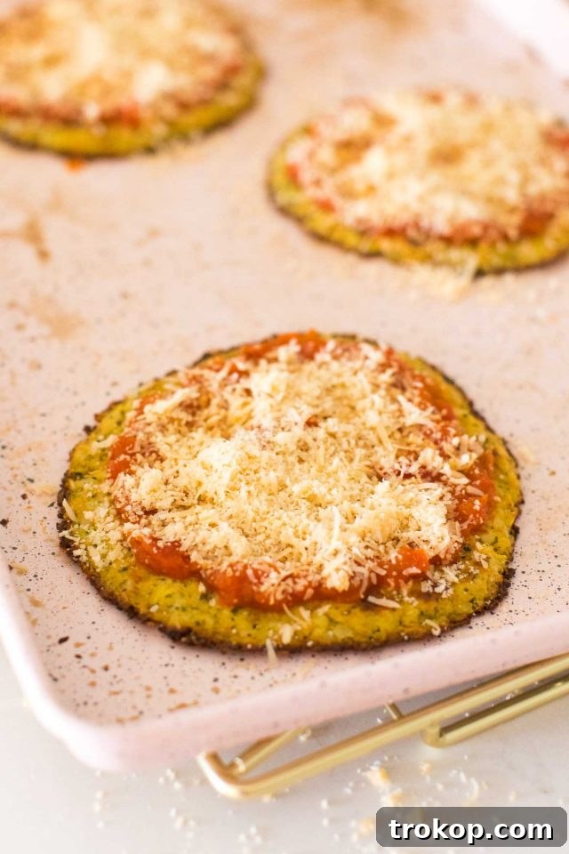 Guilt-Free Cauliflower Pizza Crust for Your Low-Carb Lifestyle 10 Homemade cauliflower pizza dough shaped into small crusts on a baking sheet, ready for toppings