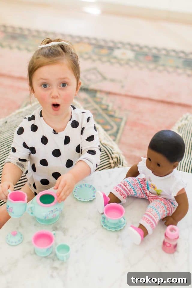 Toddler girl and Bitty Baby doll, highlighting playtime and family time indoors