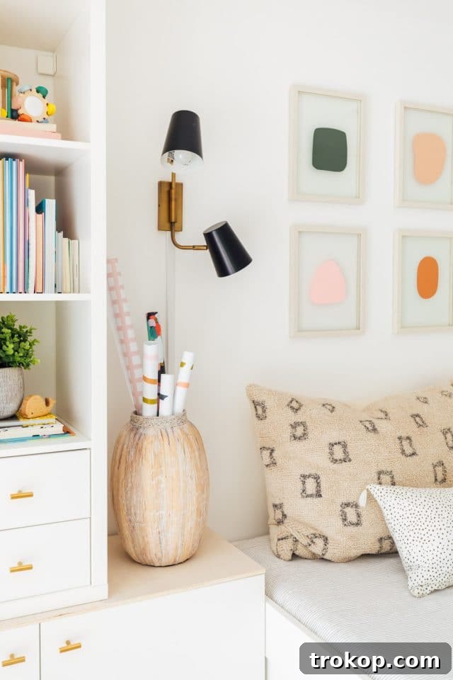 Playroom Makeover: DIY Faux Built-In Cabinets for Organized Fun 12 Kids wall art above daybed with sleek black wall sconces