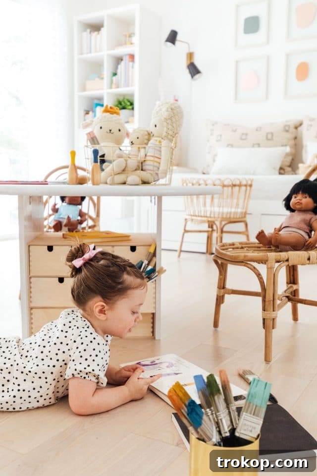 Playroom Makeover: DIY Faux Built-In Cabinets for Organized Fun 4 Little girl playing with craft supplies in an organized playroom