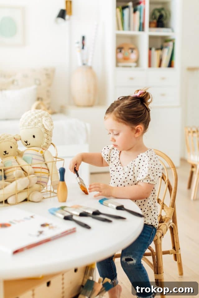Upcycled Ikea Play Table Project 3 A child happily painting at her new DIY kids play table
