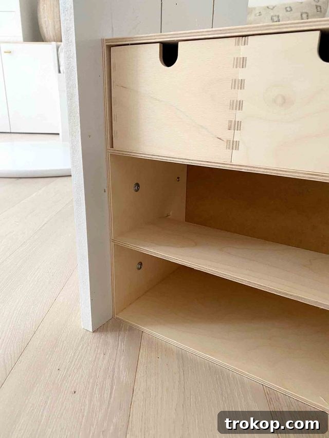 Upcycled Ikea Play Table Project 9 Step 2 in making a DIY Kids Table: Attaching storage units to the wooden base