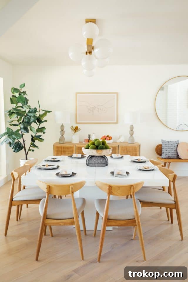 Revitalized Open-Plan Living and Dining Space 11 Dining room chairs in light oak, complementing the mid-century modern style of the home.