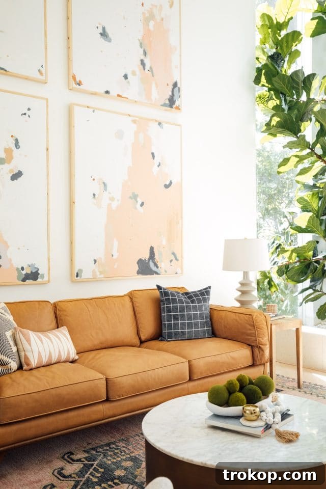 Revitalized Open-Plan Living and Dining Space 5 Close-up of the Timber sofa from Article, showcasing its beautiful color and comfortable design.