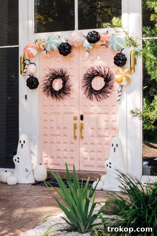 Boo-tiful Door Decor Cute Halloween Candy and Ghosts 13 angle view of a pink front door with halloween door decor