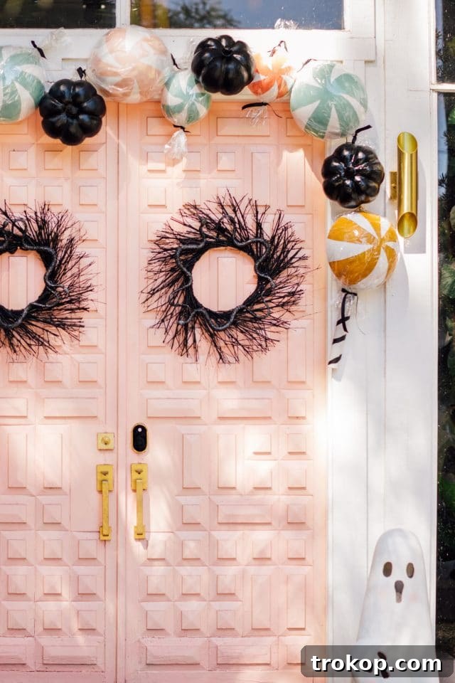 Boo-tiful Door Decor Cute Halloween Candy and Ghosts 14 pink door with fake candy decorations and a ghost