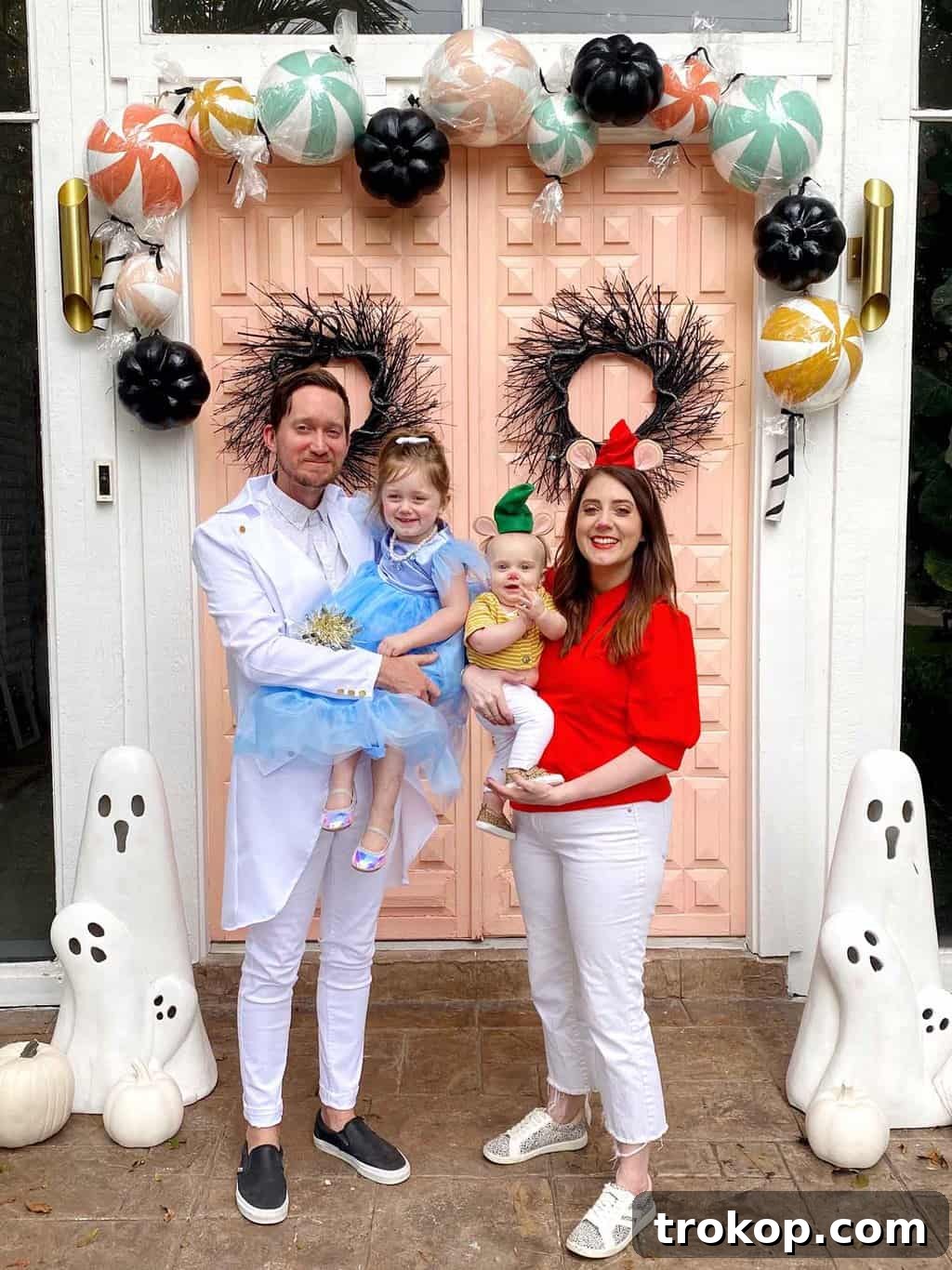Little girl dressed as Cinderella in a polka dot play tent for a backyard Halloween