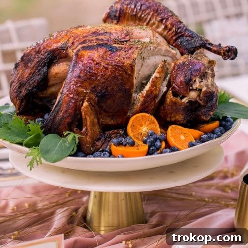 photo of a sliced thanksgiving air fryer turkey with berries and greens