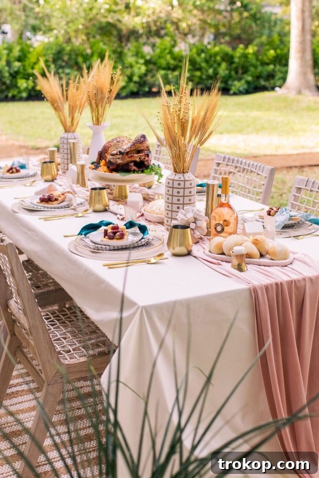 A family gathered around a beautifully decorated outdoor Thanksgiving table, enjoying dinner with the air fryer turkey as the centerpiece.