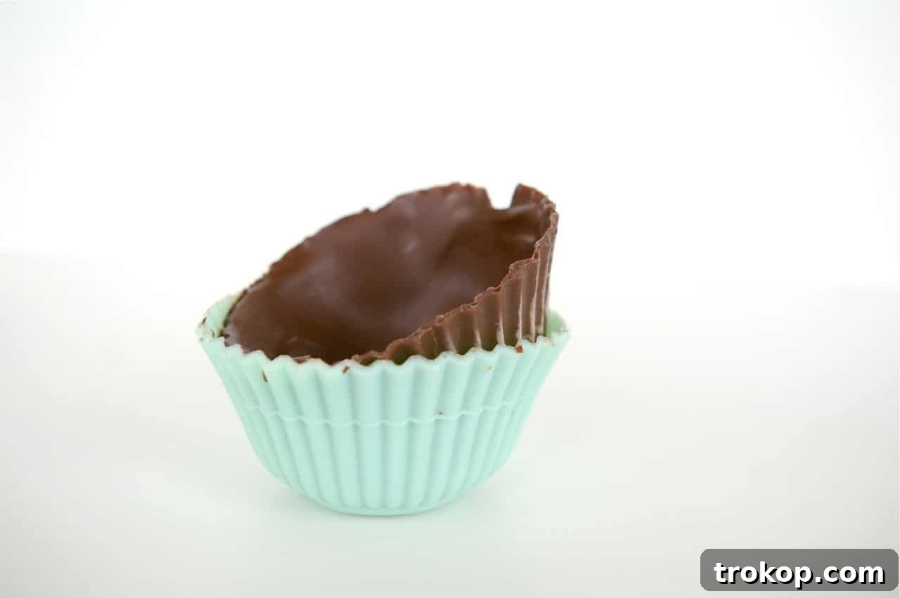 Releasing chocolate liners from silicone molds for ice cream cupcakes.