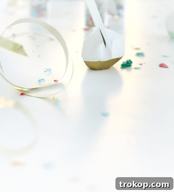 Close-up of DIY geometric place card holders in mint and gold