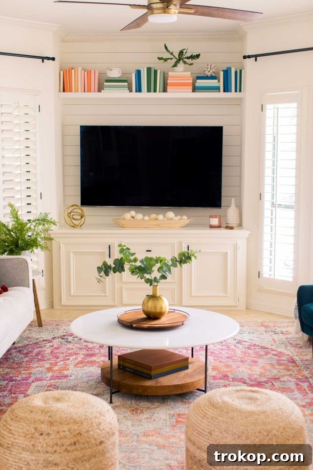 Modern family room makeover featuring a sleek TV setup, shiplap accent wall, and new furniture.