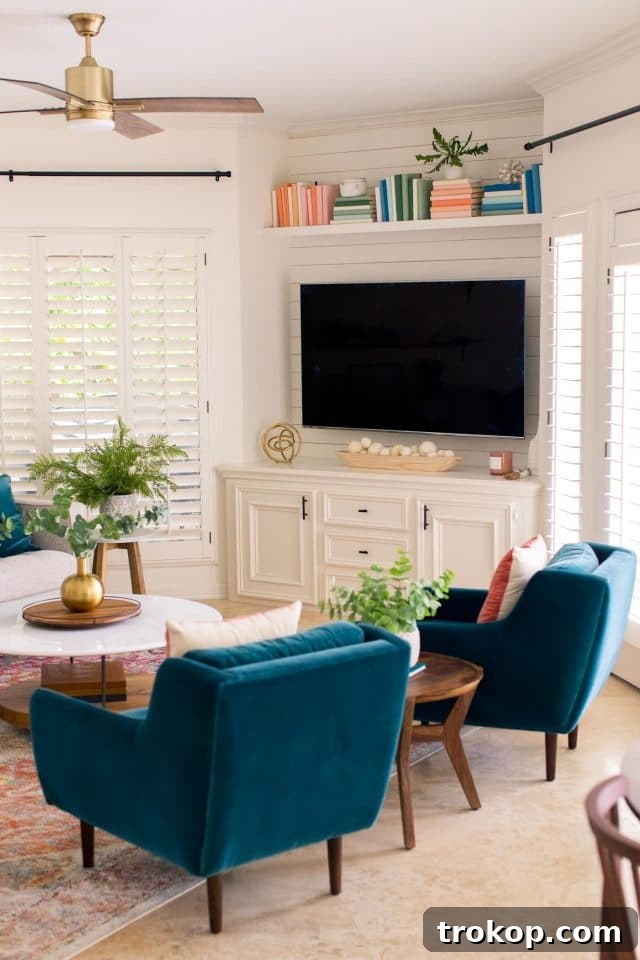 Angled view of the living room, showing the TV, coffee table, and DIY bookshelf arrangement.