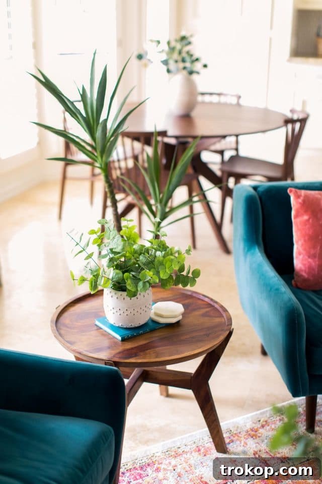 Elegant end table placed between two accent chairs, showcasing thoughtful decor.