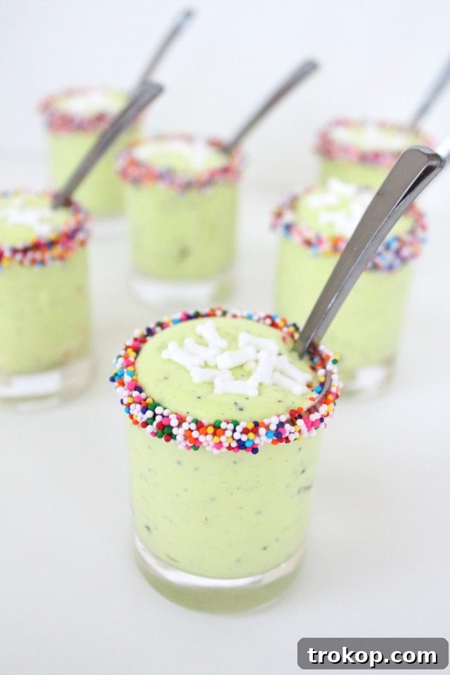 Delightfully green Monster Guts Halloween dessert cups ready for a spooky party.