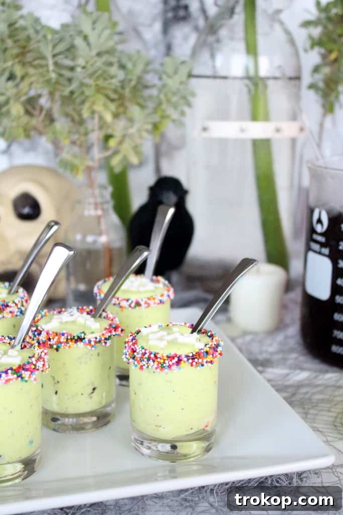 Monster Guts dessert cups in various stages of assembly, showcasing the fun and easy preparation.