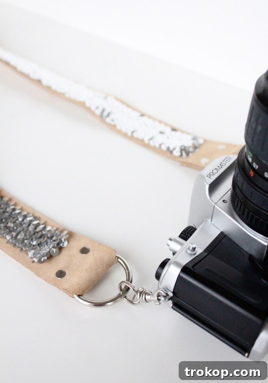 Finished DIY no-sew sequin camera strap attached to a camera