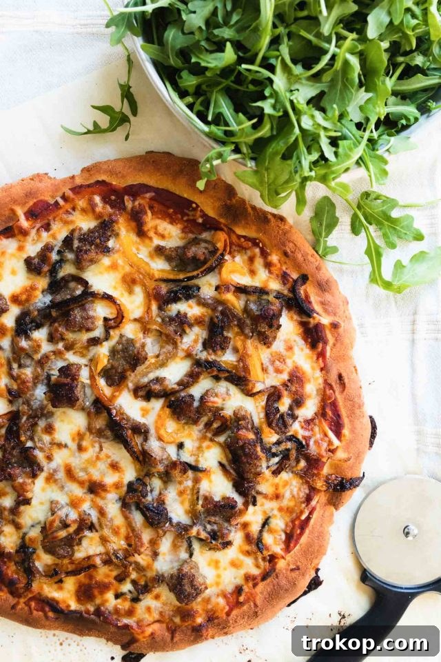 The Perfect Keto Pizza Crust 3 A close-up photo of the gluten-free, low-carb keto pizza crust, expertly sliced and adorned with delicious keto-friendly toppings.