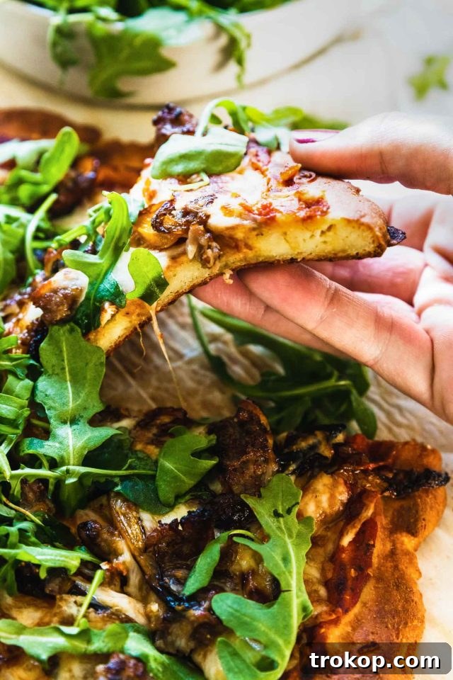 The Perfect Keto Pizza Crust 4 A delectable keto pizza crust, sliced and topped with a variety of keto-friendly ingredients, showcasing its appeal.