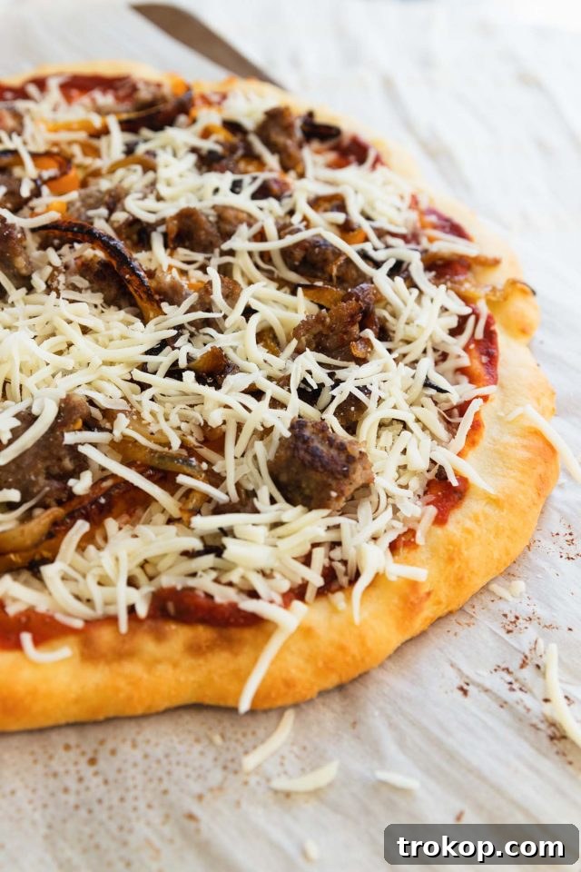 The Perfect Keto Pizza Crust 7 Various keto-friendly toppings, including meats, cheeses, and vegetables, being artfully arranged on a homemade keto pizza crust.