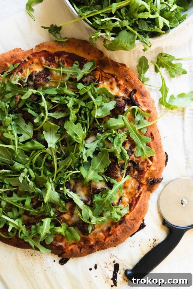The Perfect Keto Pizza Crust 8 A perfectly baked, low-carb keto pizza, sliced and ready to be enjoyed as a healthy dinner option.