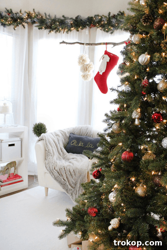A festive setup showcasing DIY hanging pom poms, elegant dessert stands, and various Martha Stewart Living Christmas decorations, perfect for holiday entertaining.