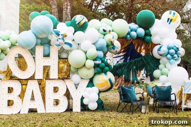 Your Essential Guide to a Drive-Thru Baby Shower 3 Horizontal photo of giant marquee letters, a lush balloon garland, and other festive drive-thru shower decorations viewed from the street
