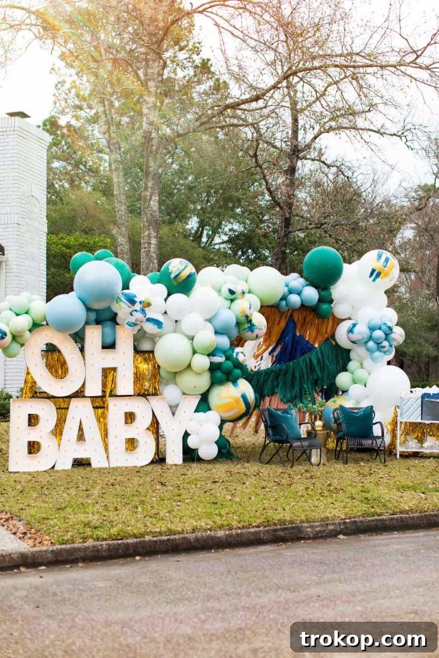 Your Essential Guide to a Drive-Thru Baby Shower 4 Street view of drive-thru baby shower decorations featuring vibrant balloons, large signs, and a welcoming setup