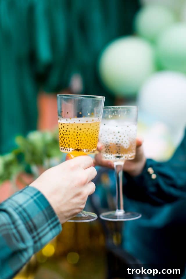 Your Essential Guide to a Drive-Thru Baby Shower 6 Two hands cheersing champagne glasses, symbolizing celebration and joy at a baby shower