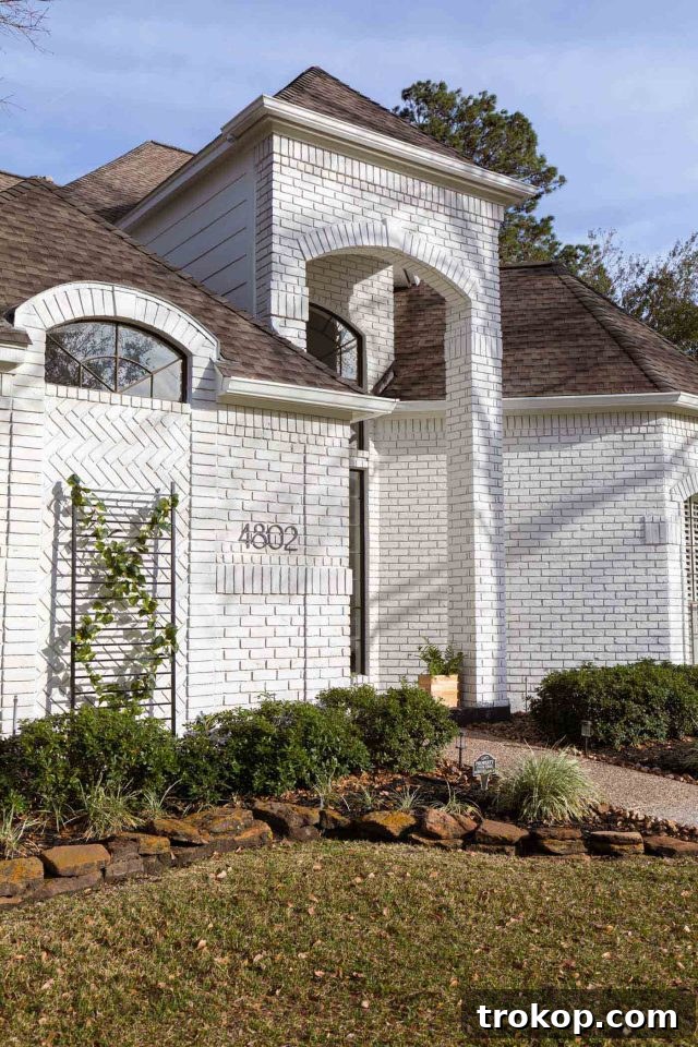 angled photo of an exterior limewash paint job on brick showcasing texture