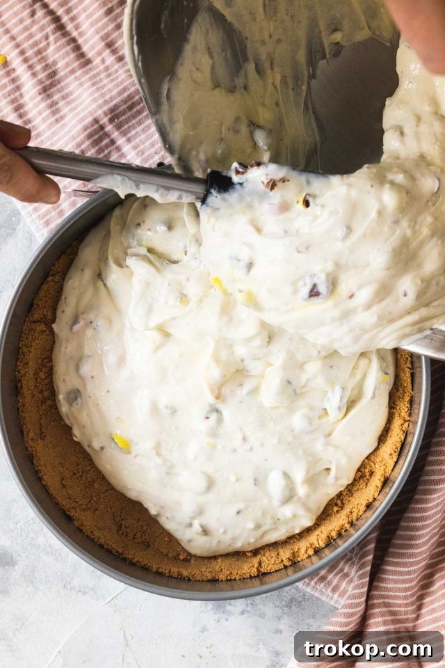 The cheesecake filling carefully assembled into the graham cracker crust, ready for its water bath and baking