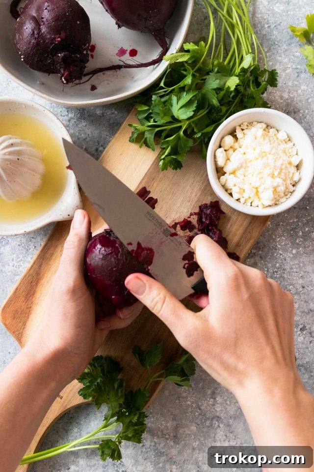 Vibrant Beetroot and Goat Cheese Salad 4 Close-up photo of beets being prepped for salad, showing them washed and trimmed on a cutting board, ready for cooking.