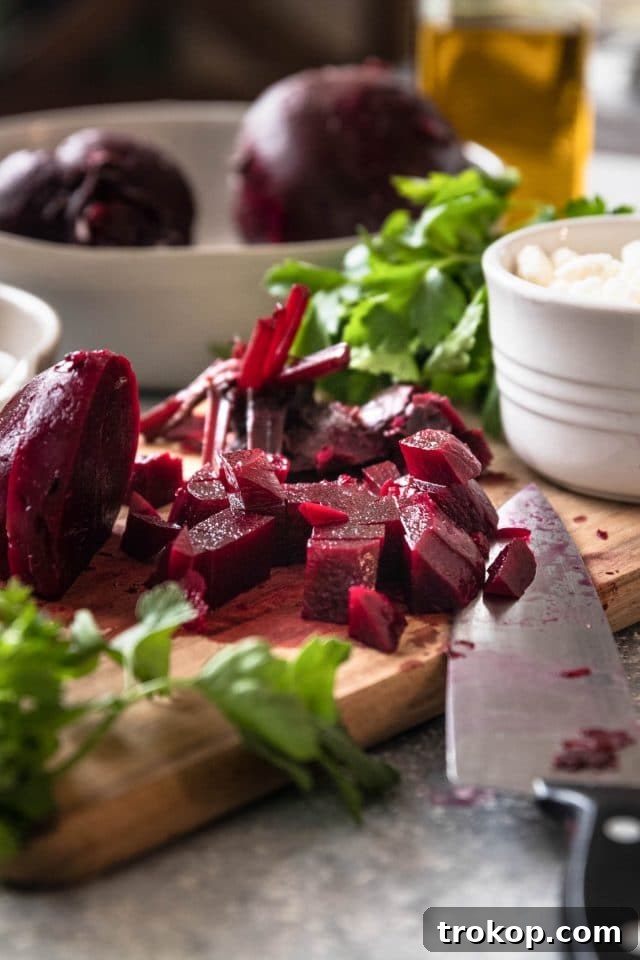 Vibrant Beetroot and Goat Cheese Salad 7 Close-up photo of perfectly cubed cooked beets in a bowl, ready to be dressed for the salad.