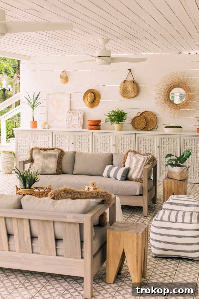 Beachy outdoor tiled patio with comfortable couches and modern decor