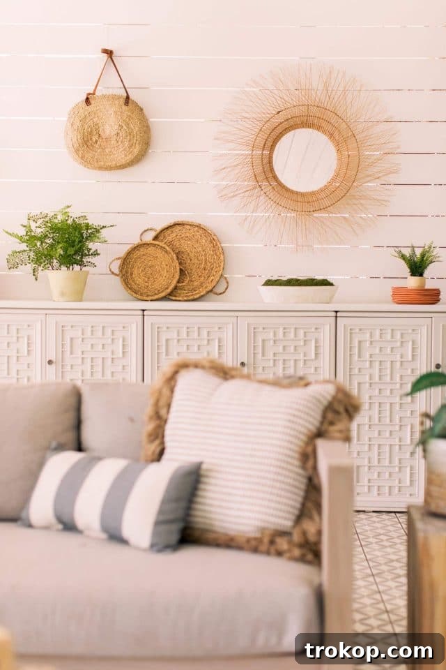 Outdoor sofa cushions arranged in front of the shiplap outdoor walls
