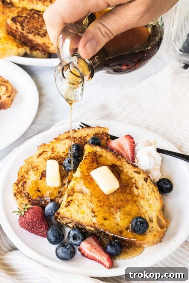 Sourdough French Toast Delight 2 Golden Sourdough French Toast topped with honey, butter, and fresh berries