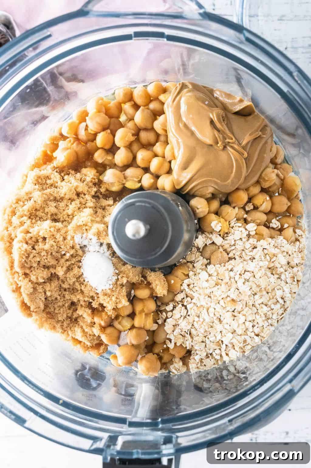 Chickpeas, nut butter, sweetener, salt, baking powder, and oats, and vanilla extract in the bowl of a food processor for the Chickpea Cookie Dough