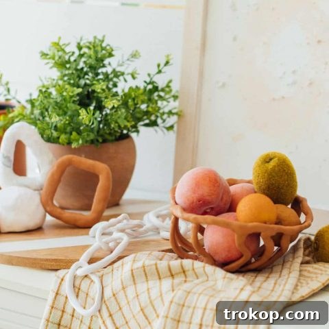 Photo of various sculptures, chain link decor, and fruit bowls made from Sculpey polymer clay