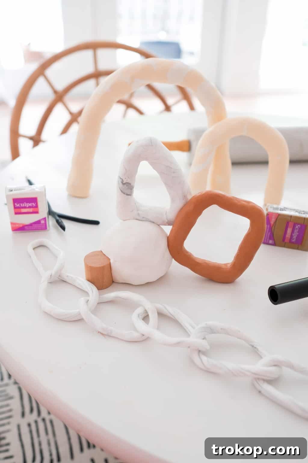 Variety of Sculpey clay creations including chain links and abstract forms
