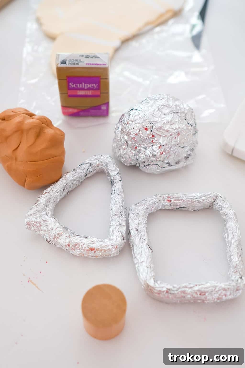 Aluminum foil being shaped into an armature mold for clay sculpture