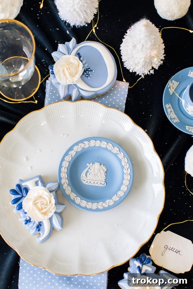 A beautifully decorated Christmas tabletop featuring festive dinnerware and accents by Ashley Rose of Sugar & Cloth