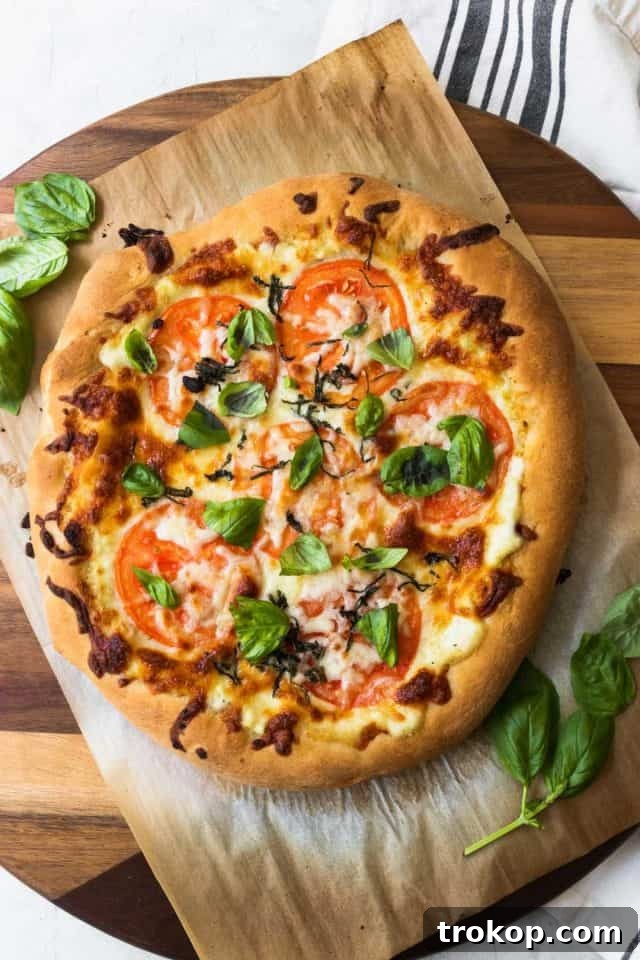 Creamy White Sauce Pizza 2 Freshly baked white pizza with melted mozzarella and herbs