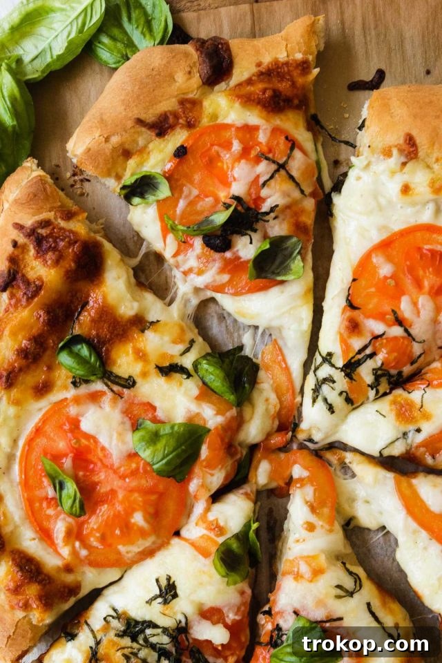 Creamy White Sauce Pizza 3 Sliced white pizza with generous toppings ready to be served