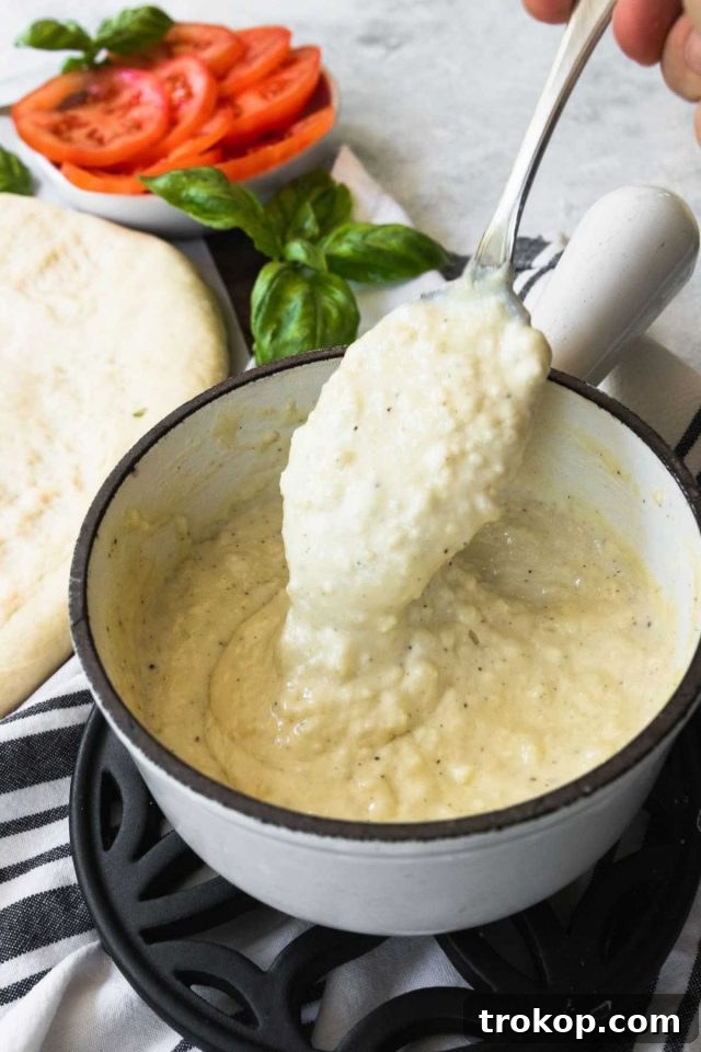 Creamy White Sauce Pizza 5 All ingredients for homemade white pizza sauce being combined in a pan