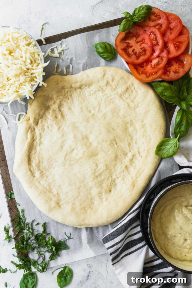 Creamy White Sauce Pizza 7 Ingredients laid out for making a white cheese pizza